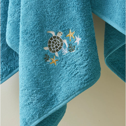 Combed cotton baby bath linen with embroidered fish